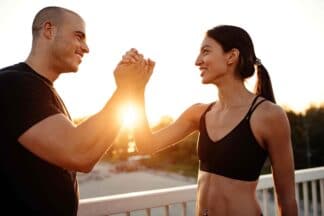 male and female dubai personal trainers working together and shaking hands