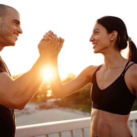 male and female dubai personal trainers working together and shaking hands