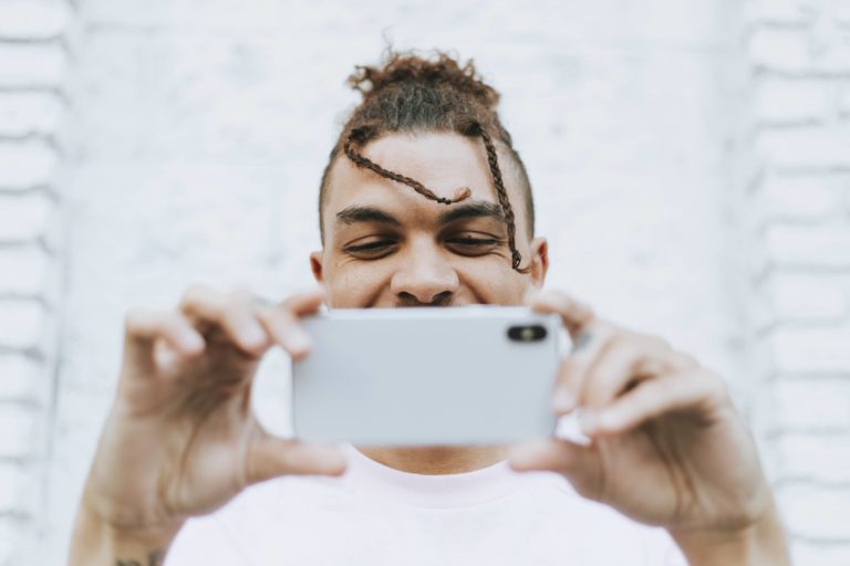 man taking a selfie in downtown C46MX5B 1 – MYFITAPE